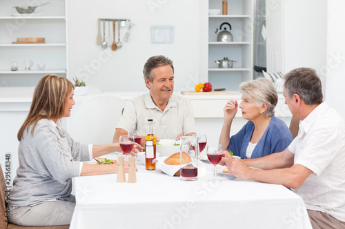 Mature friends taking lunch together