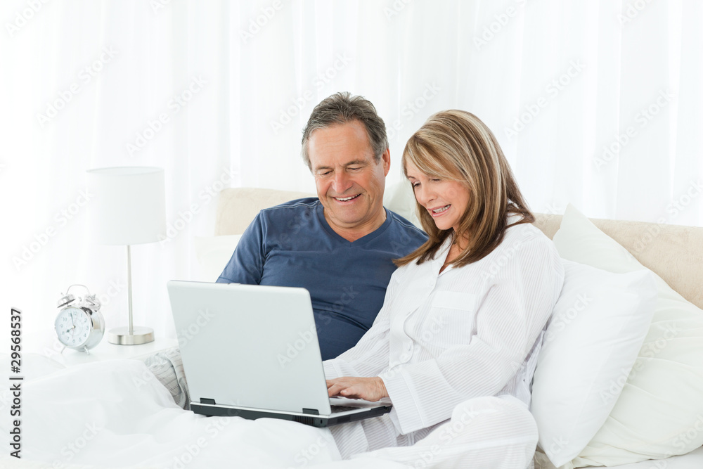 Mature lovers looking at their laptop Stock Photo | Adobe Stock