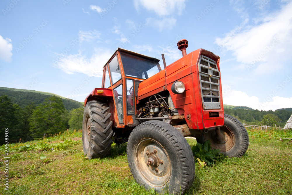 Old abandoned red tractor with removed trademarks Old abandoned red tractor with removed trademarks