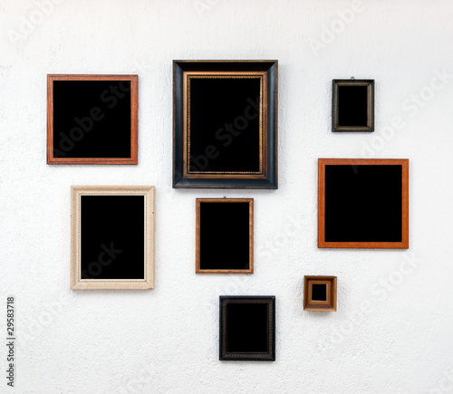 Picture frames on textured white wall