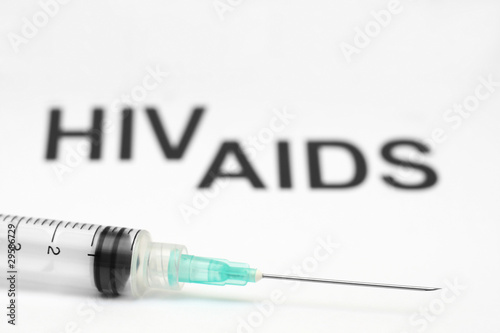 Close up of syringe against aids background