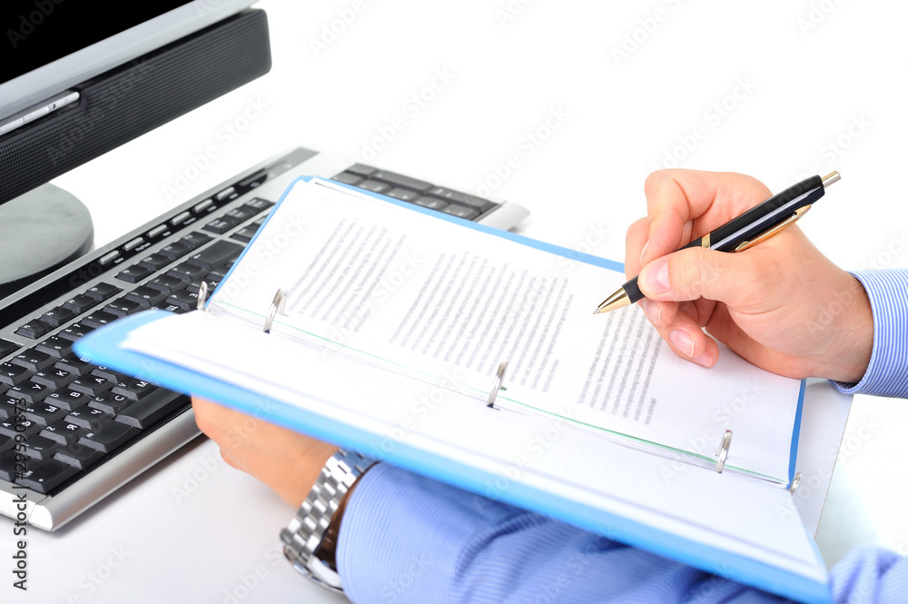 Businessman is checking a paperwork and making notes Businessman is checking a paperwork and making notes