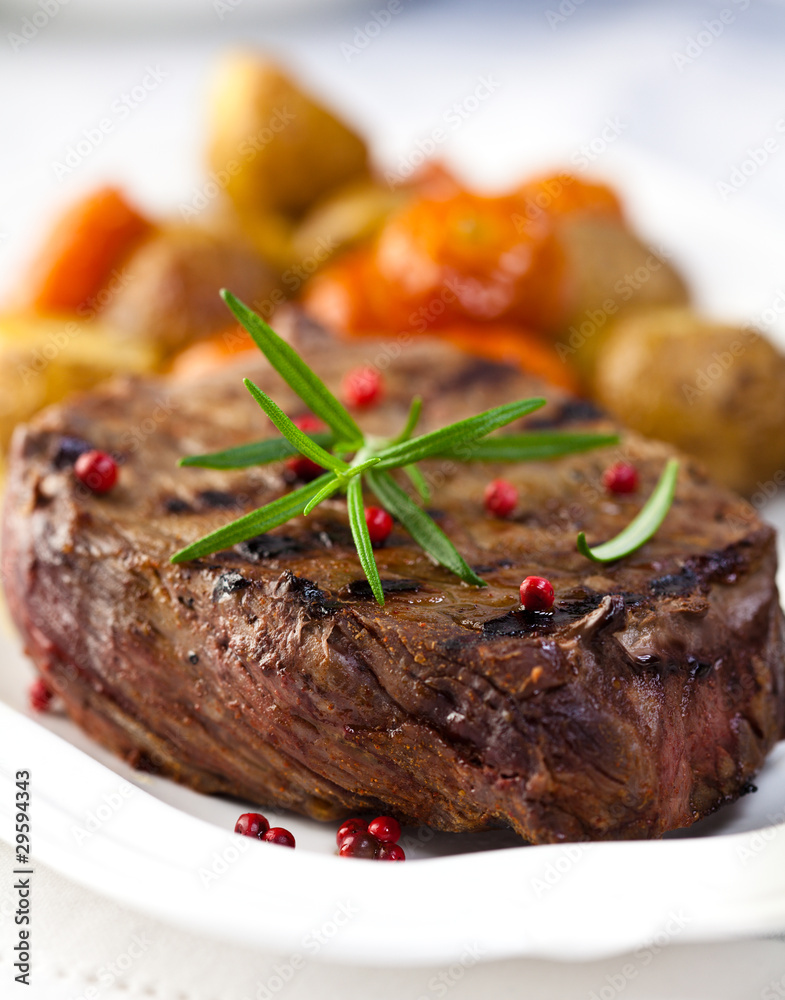 Closeup of grilled steak served with baked vegetables Closeup of grilled steak served with baked vegetables