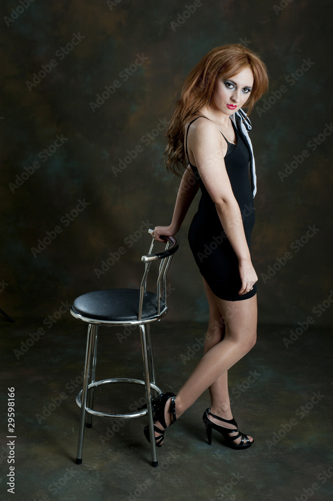 Pretty female posing with bar stool