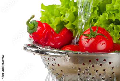 Obraz na plátně Tomatoes and peppers and lettuce in a colander