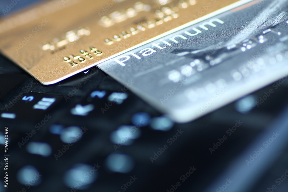 Gold and platinum Credit cards on keyboard backrgound