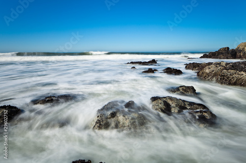 Scenic view of waves breading on rocky ocean coastline