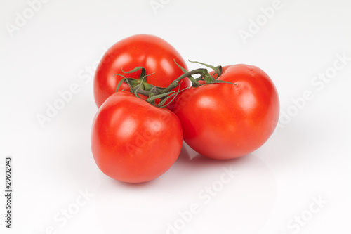 Three vine tomatoes on a white background