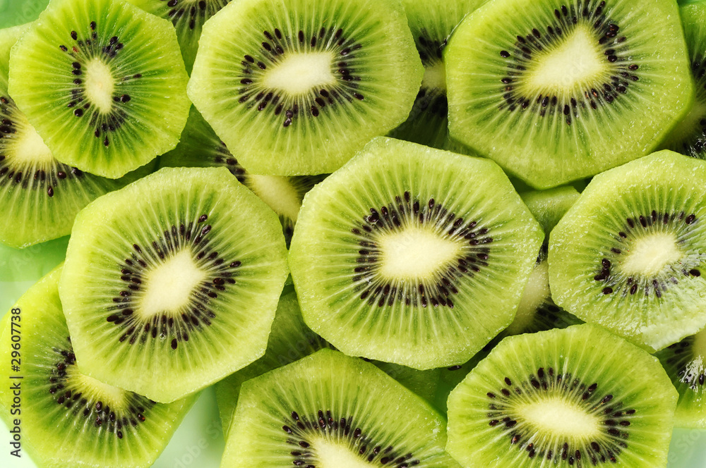 Fresh kiwifruit slices on the green plate. Fresh kiwifruit slices on the green plate.