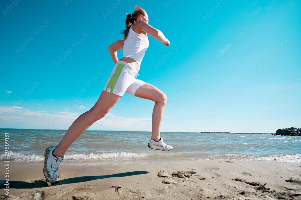 Sport woman running in sea coast Sport woman running in sea coast