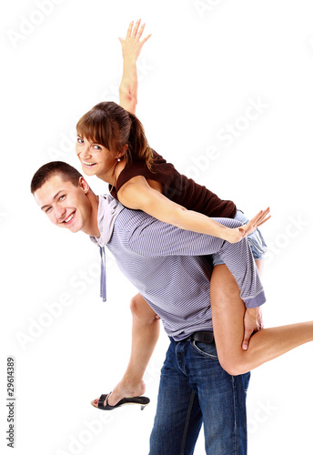 Happy young female enjoying a piggyback ride on