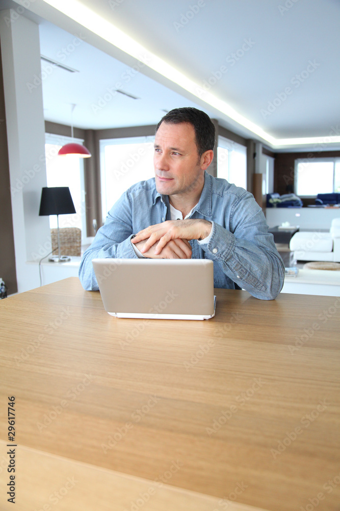 Fototapeta premium Adult man surfing on internet at home