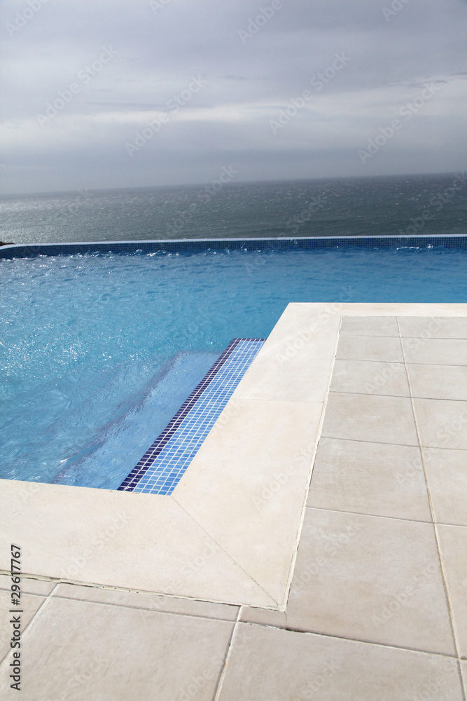 Modern swimming-pool with view towards the ocean