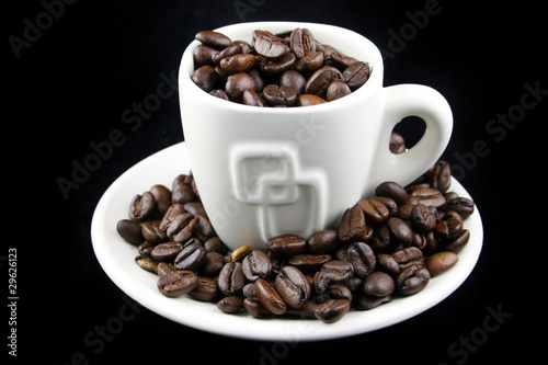 Coffee beans on a white cup