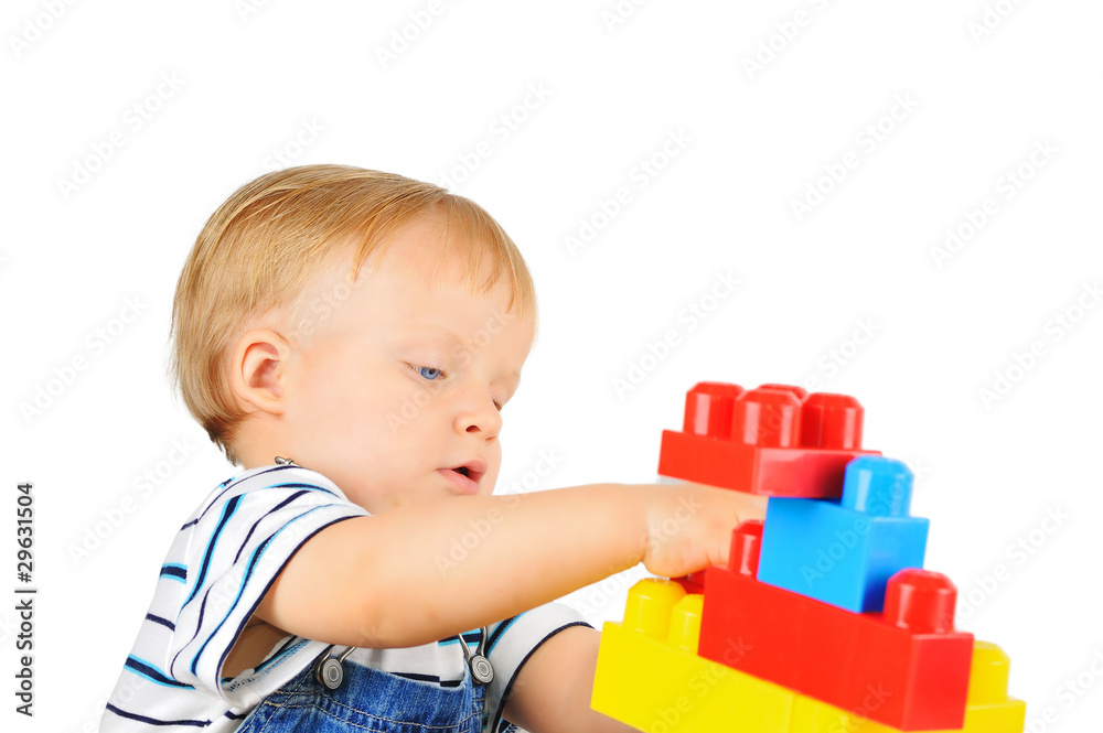 Cute little boy is playing with building blocks Cute little boy is playing with building blocks