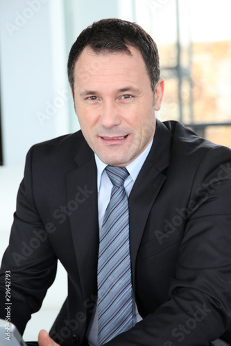 Portrait of businessman wearing dark suit © goodluz