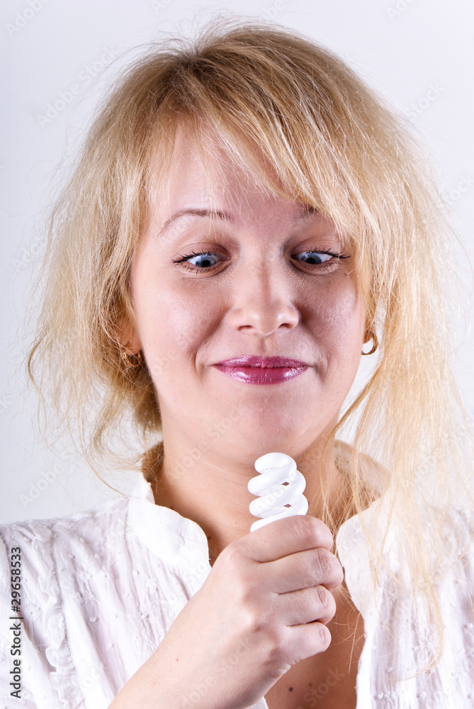 Beautiful blonde girl with a lamp in his hand.