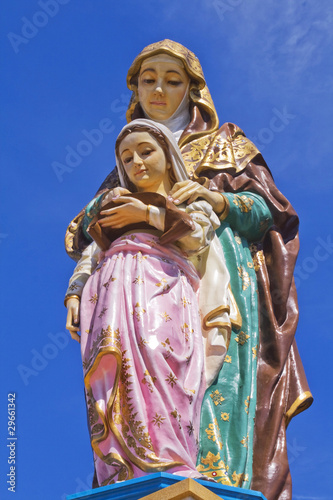 Statue of the Virgin. Blue background.