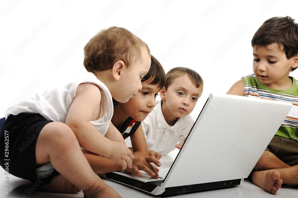 Group of children playing on white laptop together.