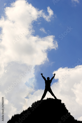 Fotografija Silhouette man stretching towards sky in achievement victory