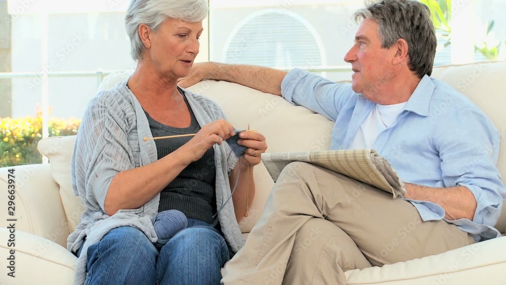 Senior couple talking in the living room Senior couple talking in the living room