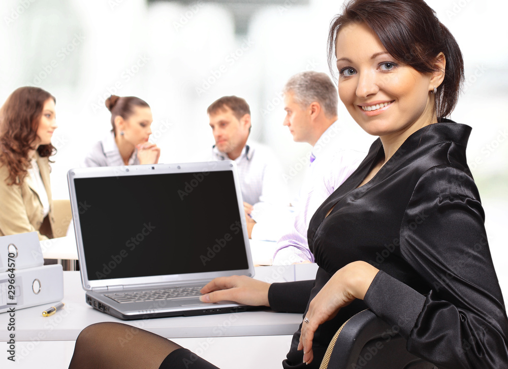 business woman with team working on laptop