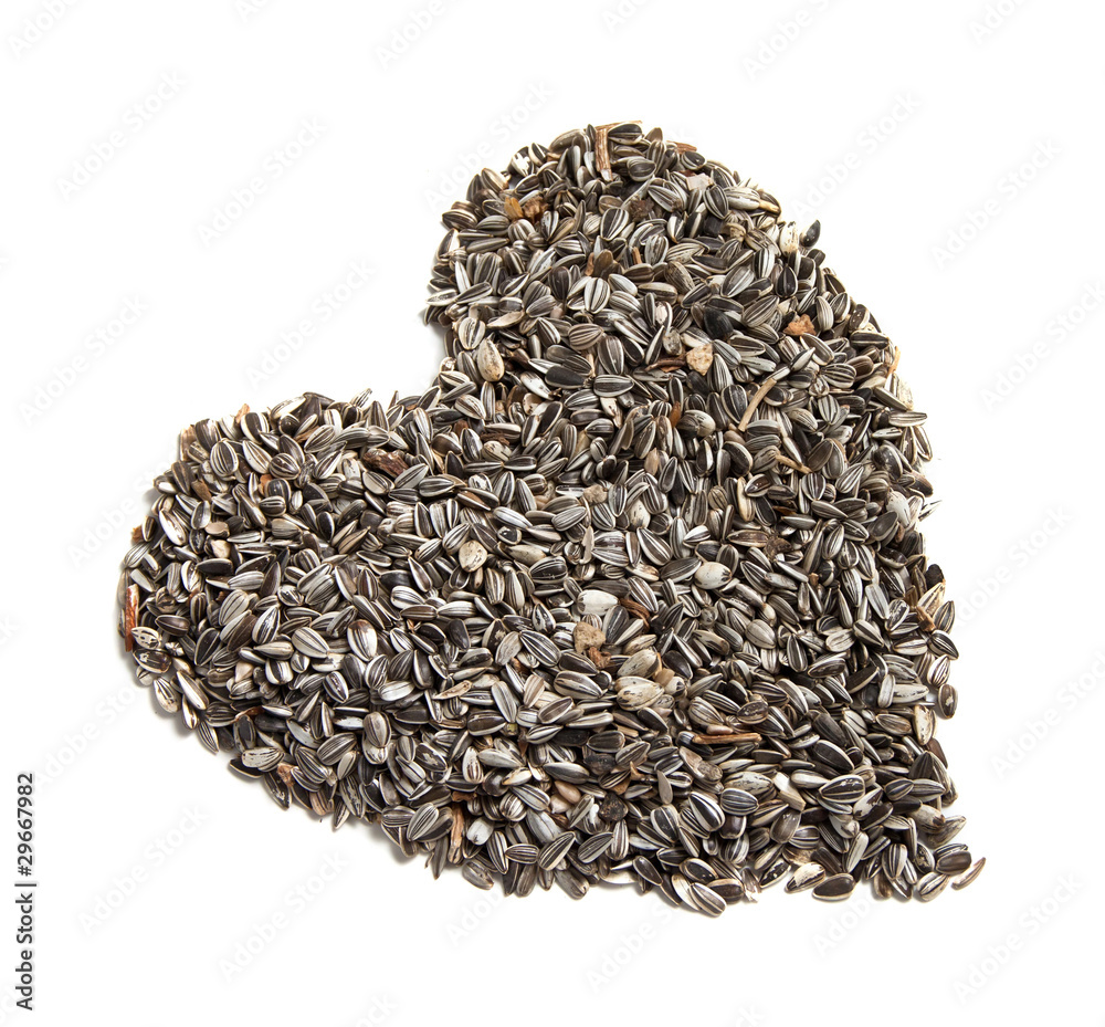 sunflower seeds background in the shape of a heart. sunflower seeds background in the shape of a heart.