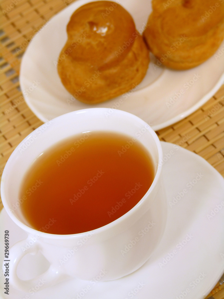 Brewing delicious cake with cream and a cup of tea Brewing delicious cake with cream and a cup of tea