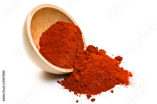 paprika powder in wooden bowl