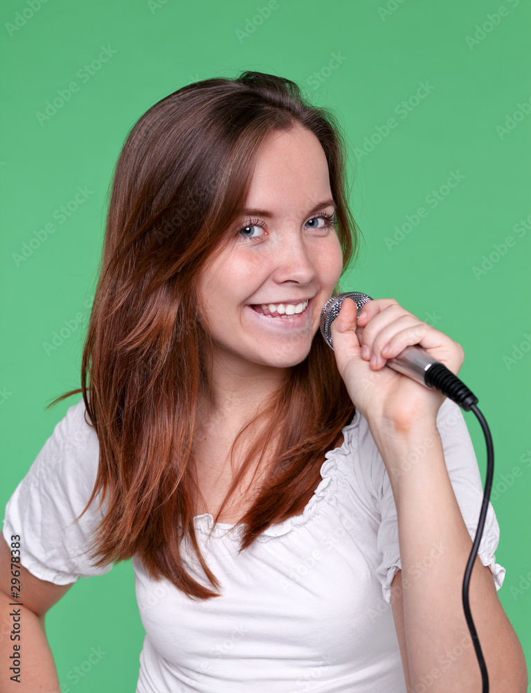 Portrait of female singer with microphone in hand Portrait of female singer with microphone in hand