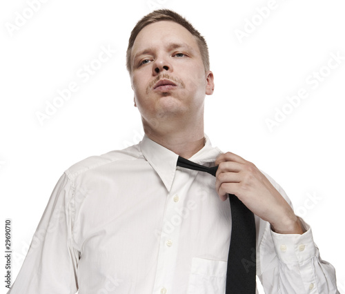 Valokuva A tired white collar worker loosening his tie.