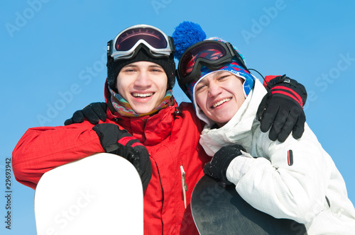 Happy sportsman with snowboards