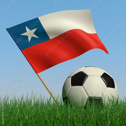 Soccer ball in the grass and the flag of Chile