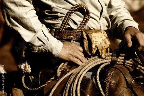 Foto Real working cowboy riding in sunset light (sepia tint)