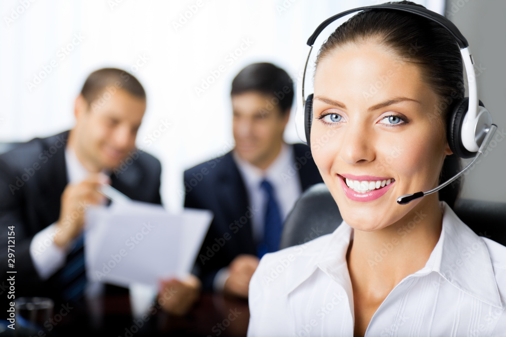 Portrait of happy smiling upport phone operator at workplace Portrait of happy smiling upport phone operator at workplace