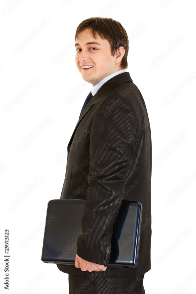 Smiling modern businessman holding laptops in hand Smiling modern businessman holding laptops in hand