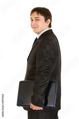 Smiling modern businessman holding laptops in hand