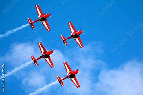 four airplanes in formation on airshow photo