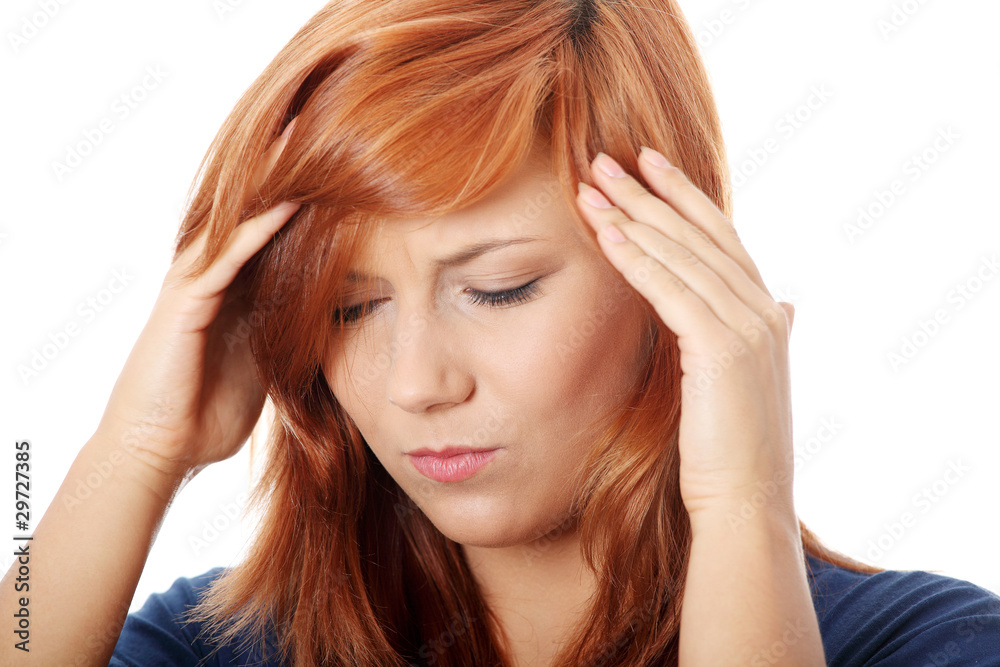 Woman with headache holding her hand to the head Woman with headache holding her hand to the head
