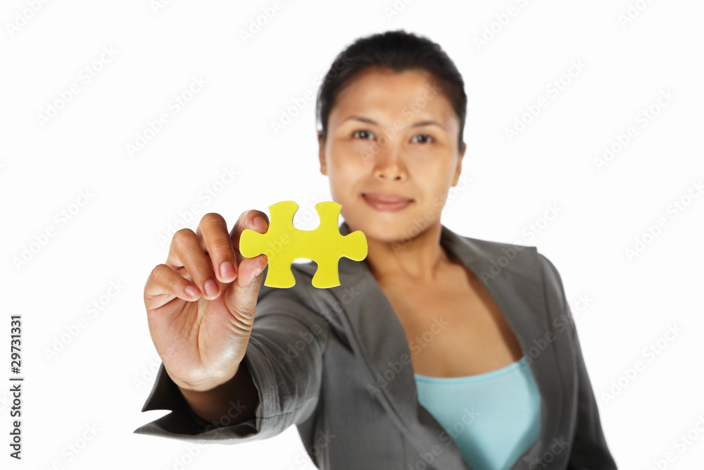 Businesswoman showing jigzaw puzzle piece