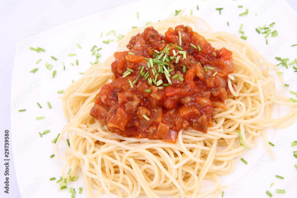 Spaghetti bolognese on a plate decorated with some chives Spaghetti bolognese on a plate decorated with some chives