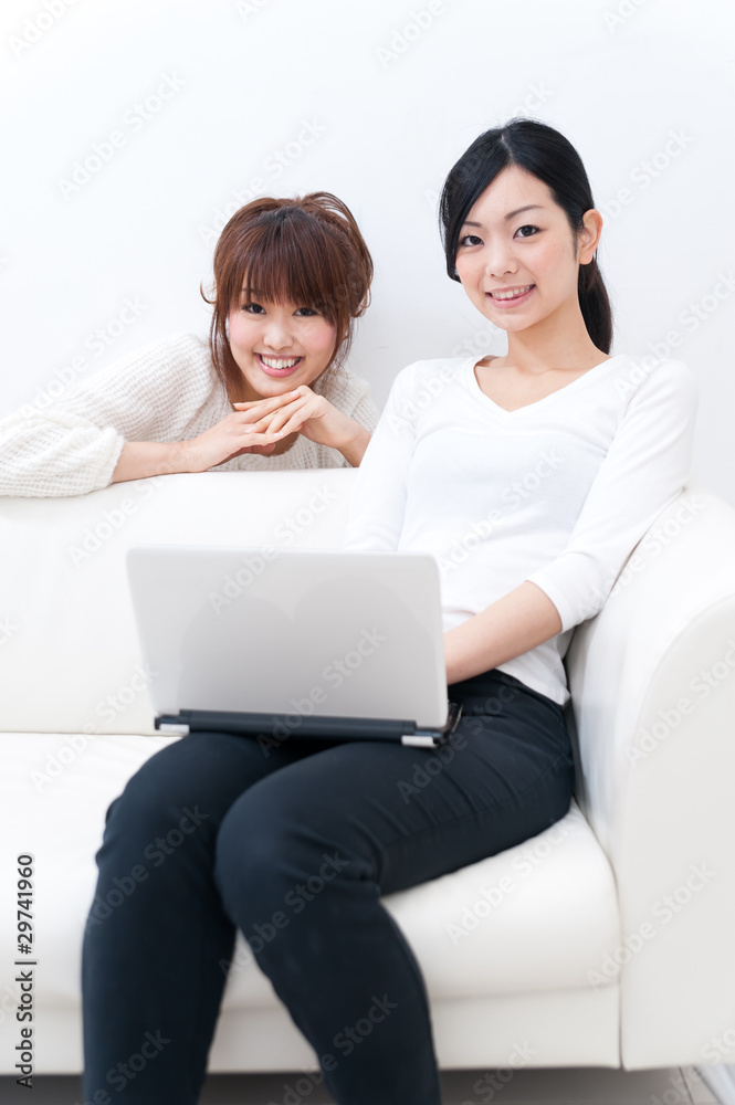 two beautiful asian women relaxing on the sofa two beautiful asian women relaxing on the sofa