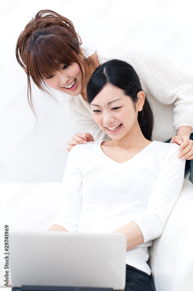 two beautiful asian women relaxing on the sofa two beautiful asian women relaxing on the sofa