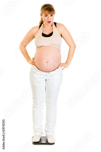 Dissatisfied with her weight pregnant standing on weight scale