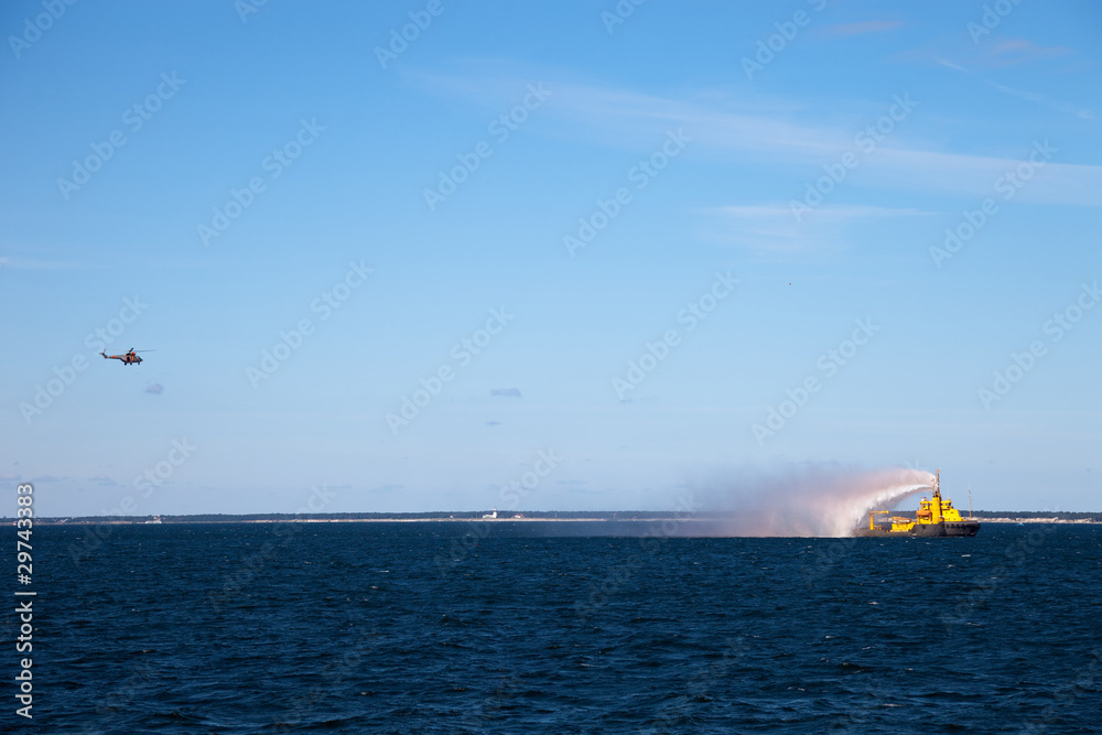 Exercises at sea - cooperation helicopter and fireboat. Exercises at sea - cooperation helicopter and fireboat.