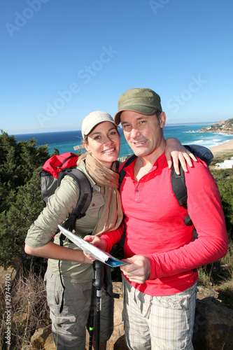 Couple looking at map on a hiking day
