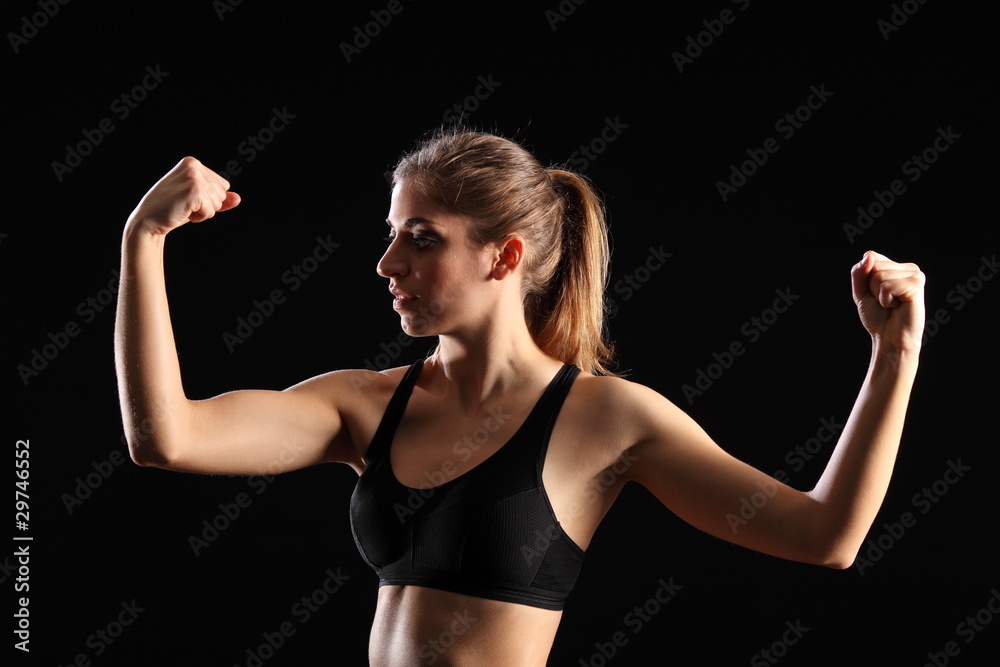 Fit woman flexing muscles during exercise workout Fit woman flexing muscles during exercise workout