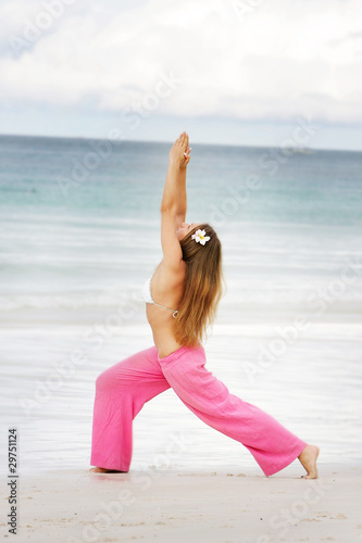 young attractive woman doing yoga on beach © Alena Yakusheva
