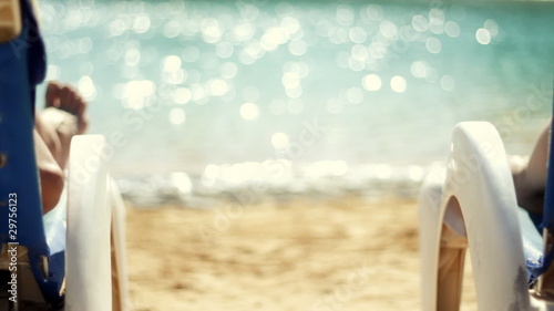 Rear view of a couple having drinks by the pool