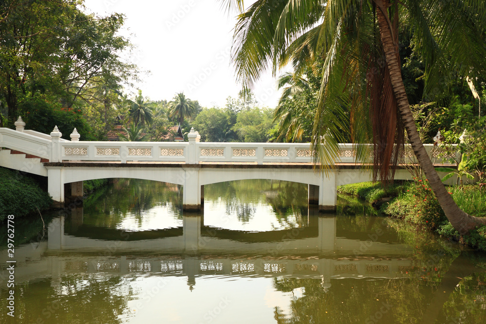Reflexion of white bridge in canal